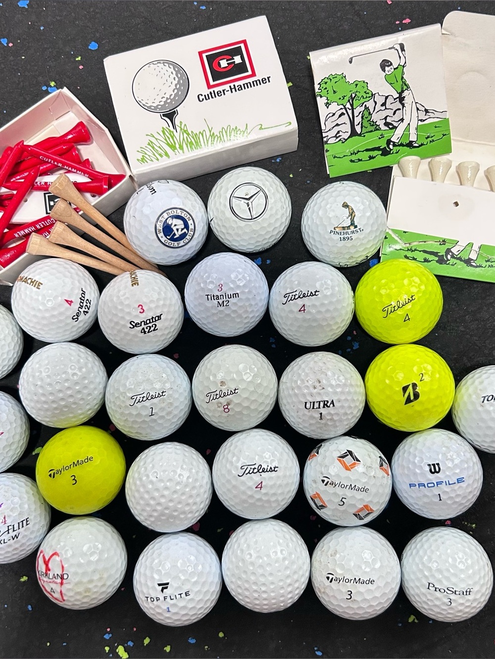 Lot of Golf Balls and Tees